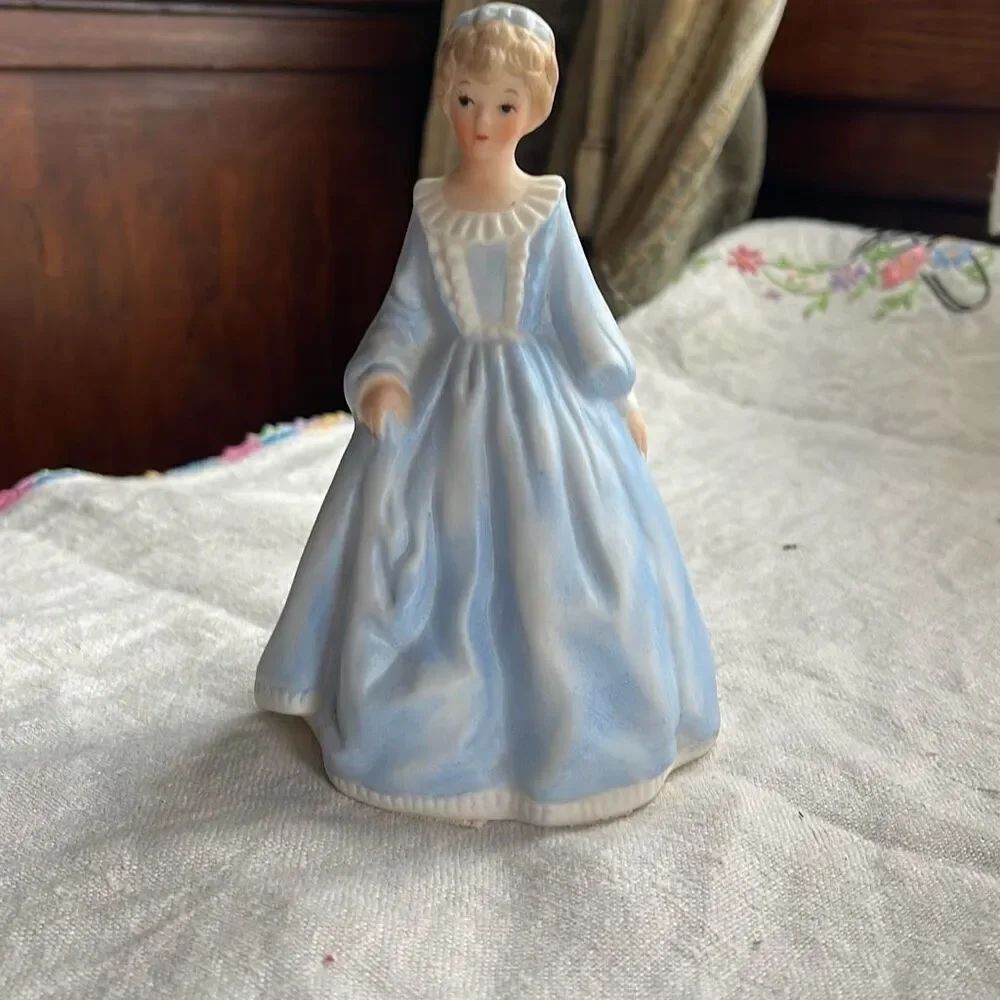 Vintage porcelain detailed figurine of Victorian girl.